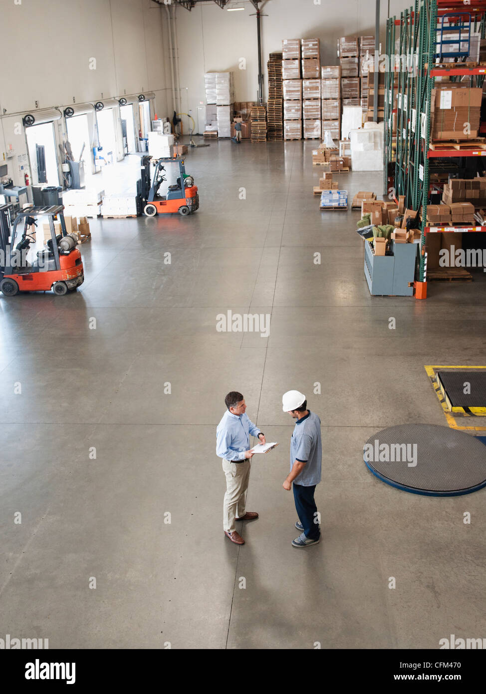 USA, California, Santa Ana, Workers talking in warehouse Stock Photo