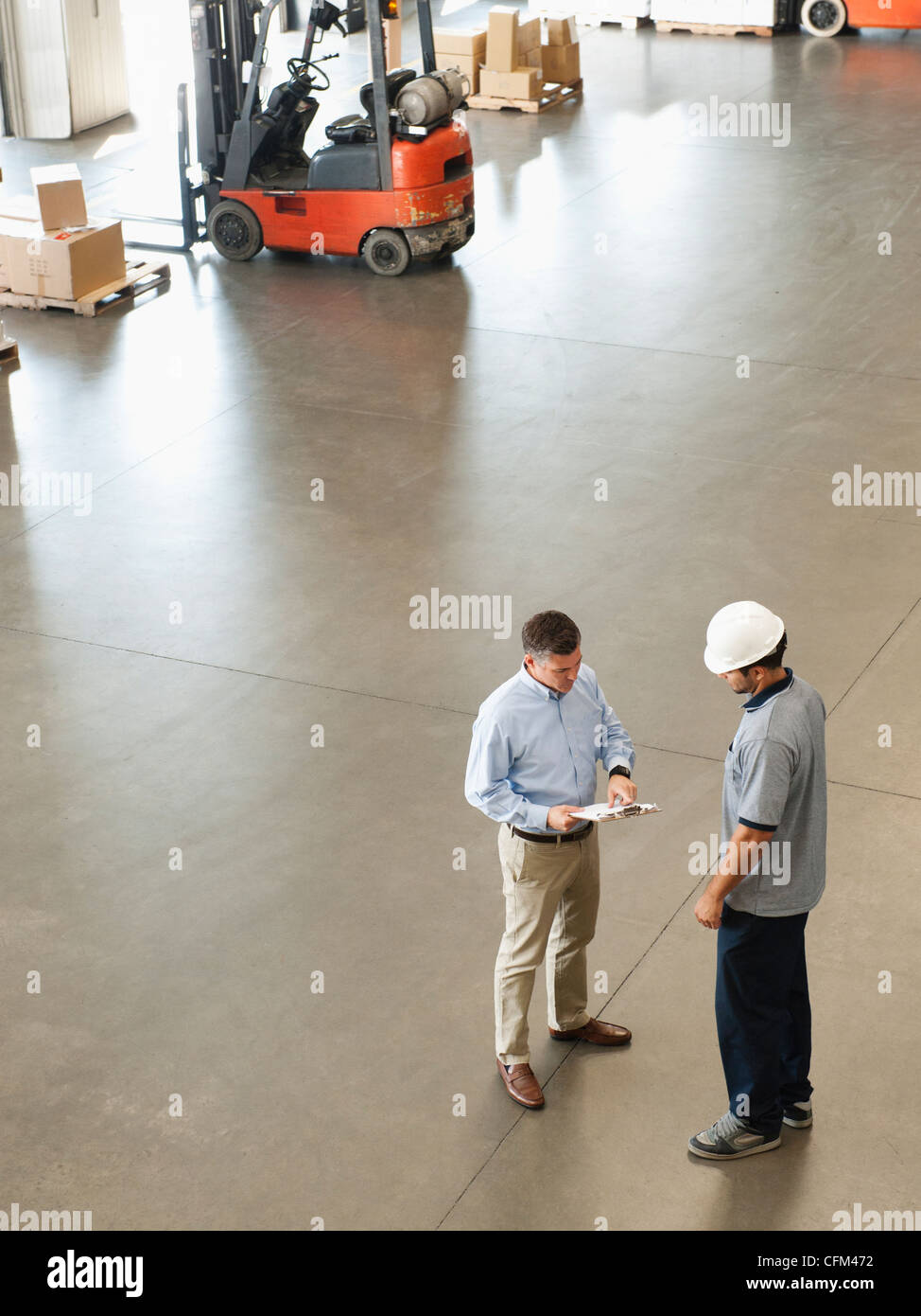 USA, California, Santa Ana, Workers talking in warehouse Stock Photo