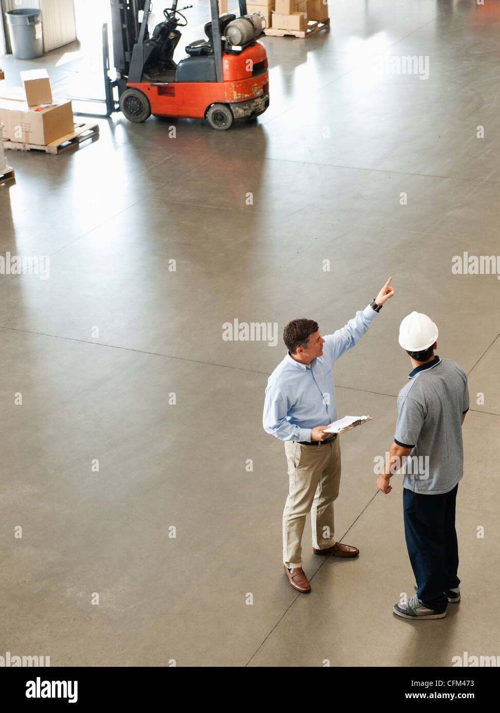 USA, California, Santa Ana, Workers talking in warehouse Stock Photo
