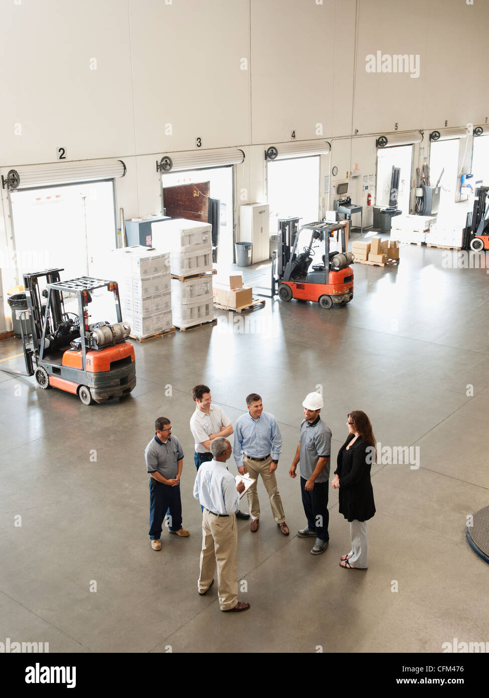 USA, California, Santa Ana, Workers talking in warehouse Stock Photo