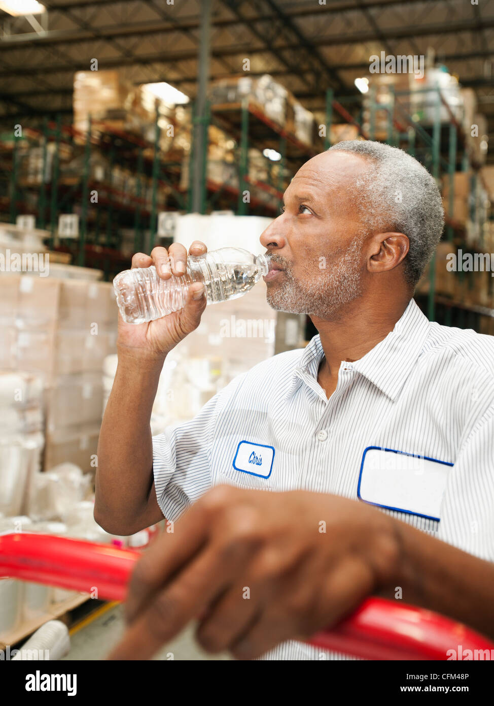 USA, California, Santa Ana, Warehouse worker drinking water Stock Photo