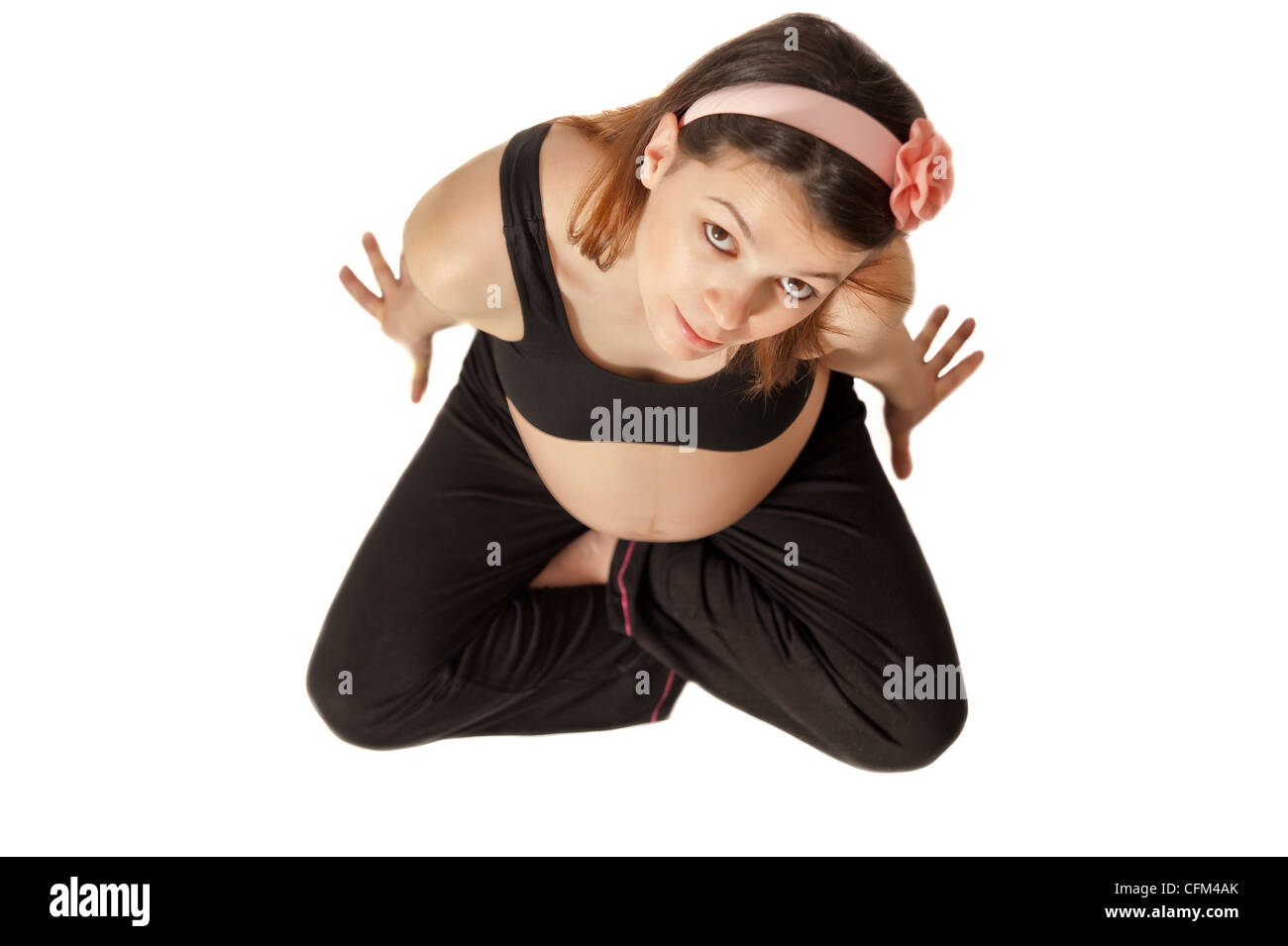 Isolated pregnant girl belly with pink rubber band on white background