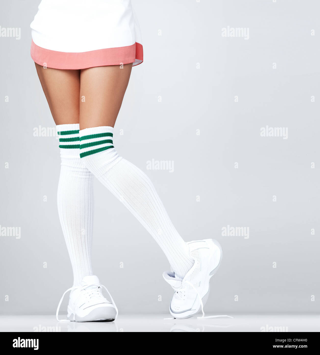 Low section of woman wearing sneakers and knee-high socks Stock Photo