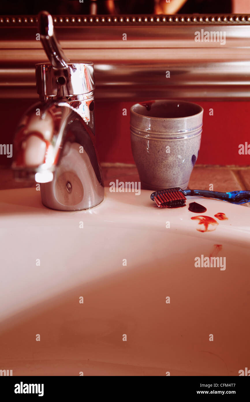 Sink with faucet and bloody toothbrush Stock Photo