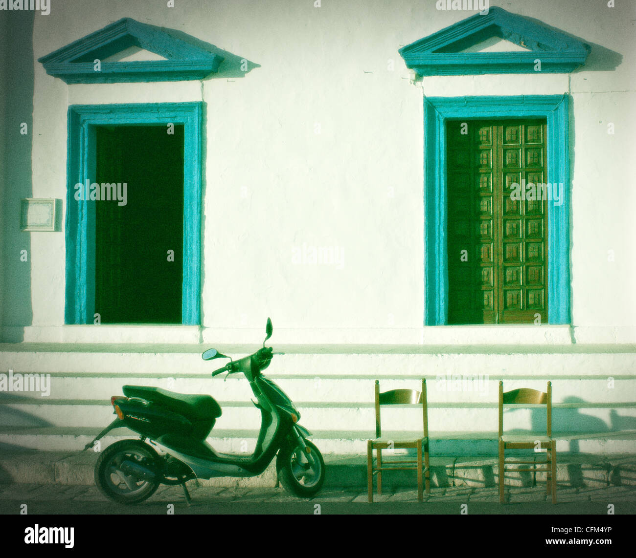 two doors, two chairs, a motor scooter Stock Photo