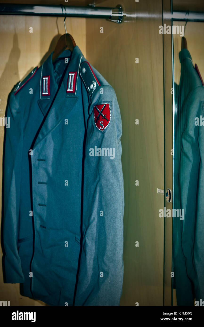An old uniform of a German officer hanging in a closet Stock Photo