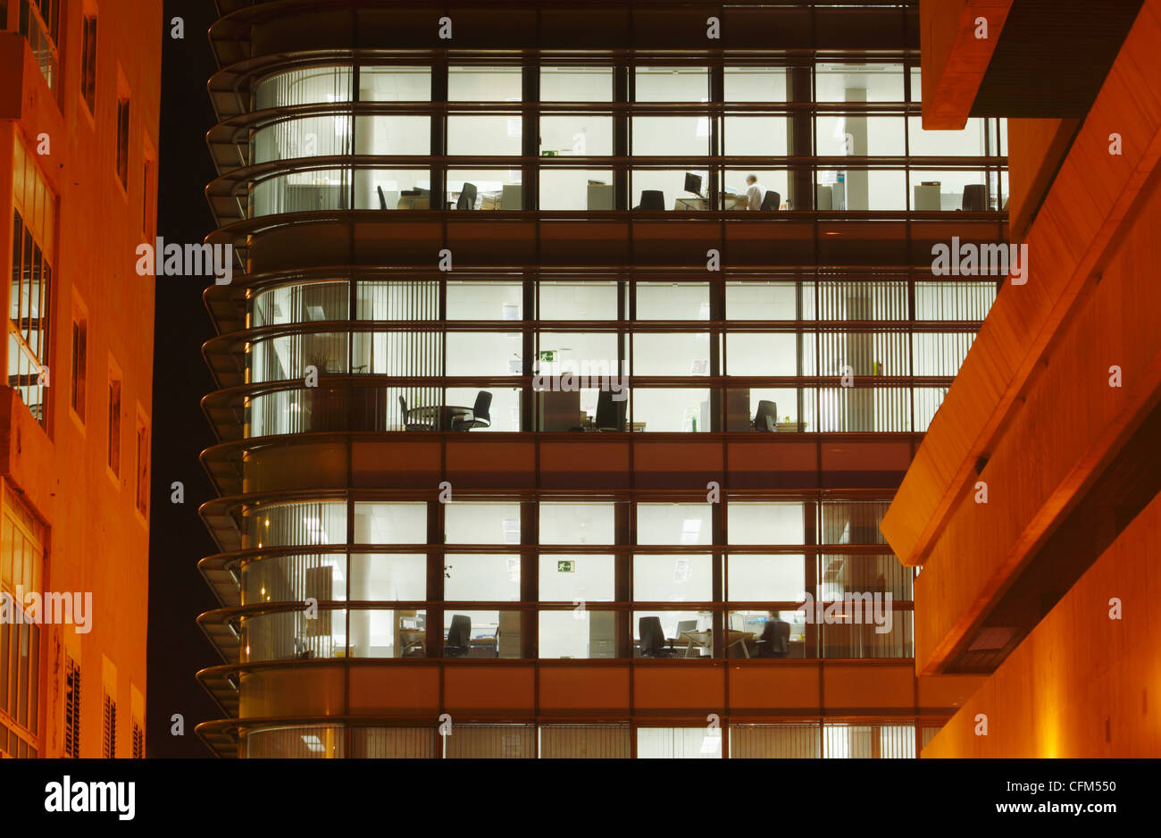 Empty offices with lights on at night Stock Photo Alamy