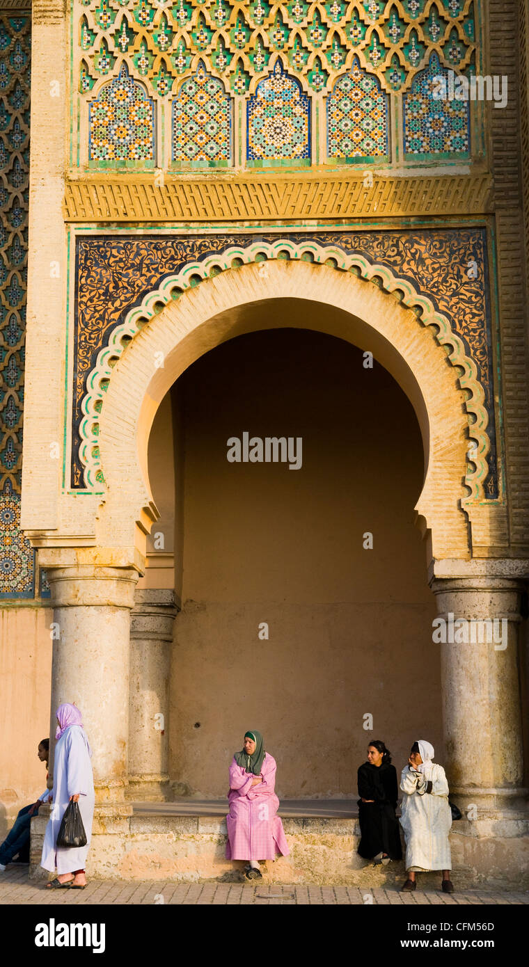 Women sitting by Bab el Mansour in Meknes. Stock Photo