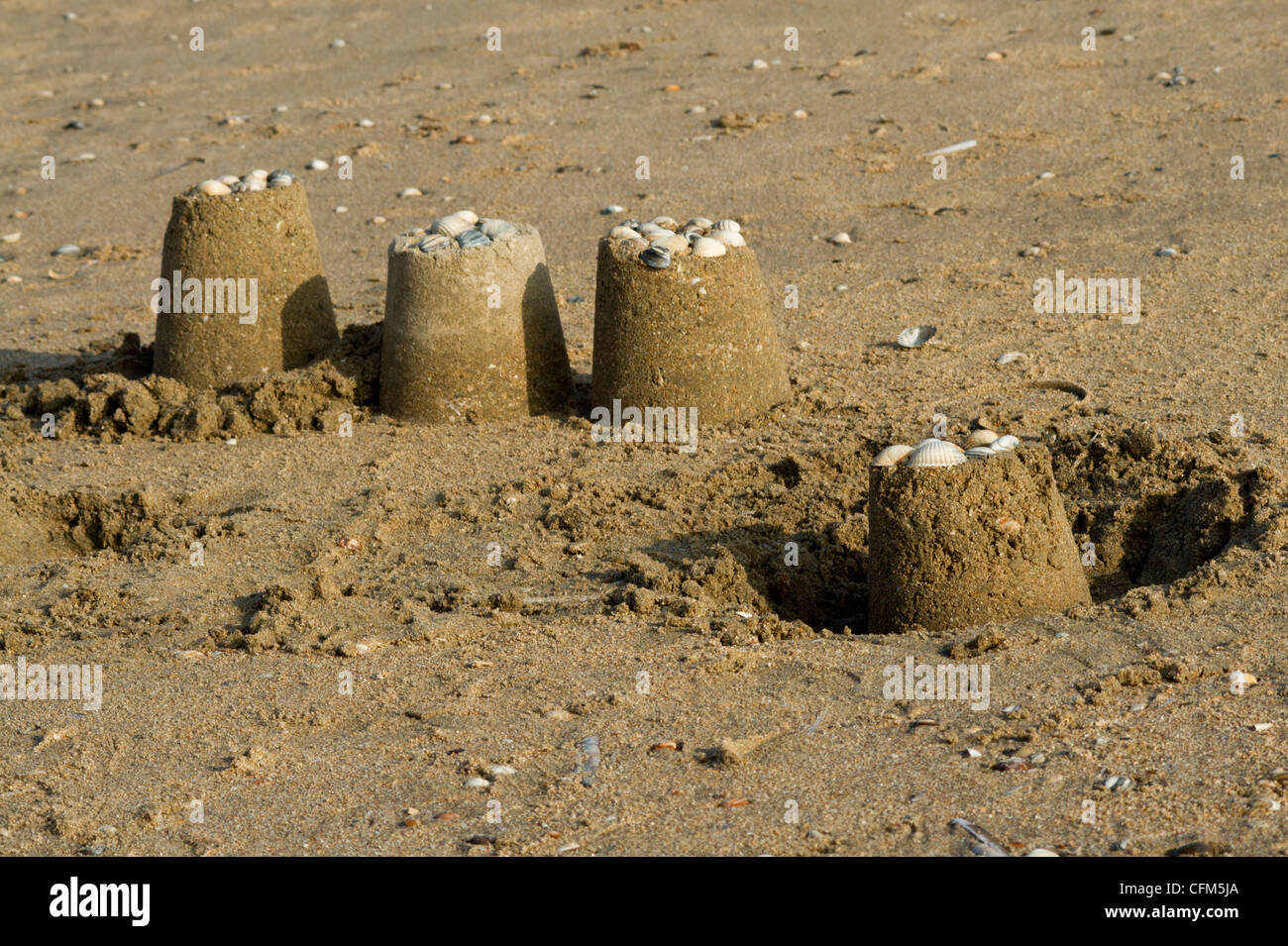 Sandcastles decorated with seashells Stock Photo