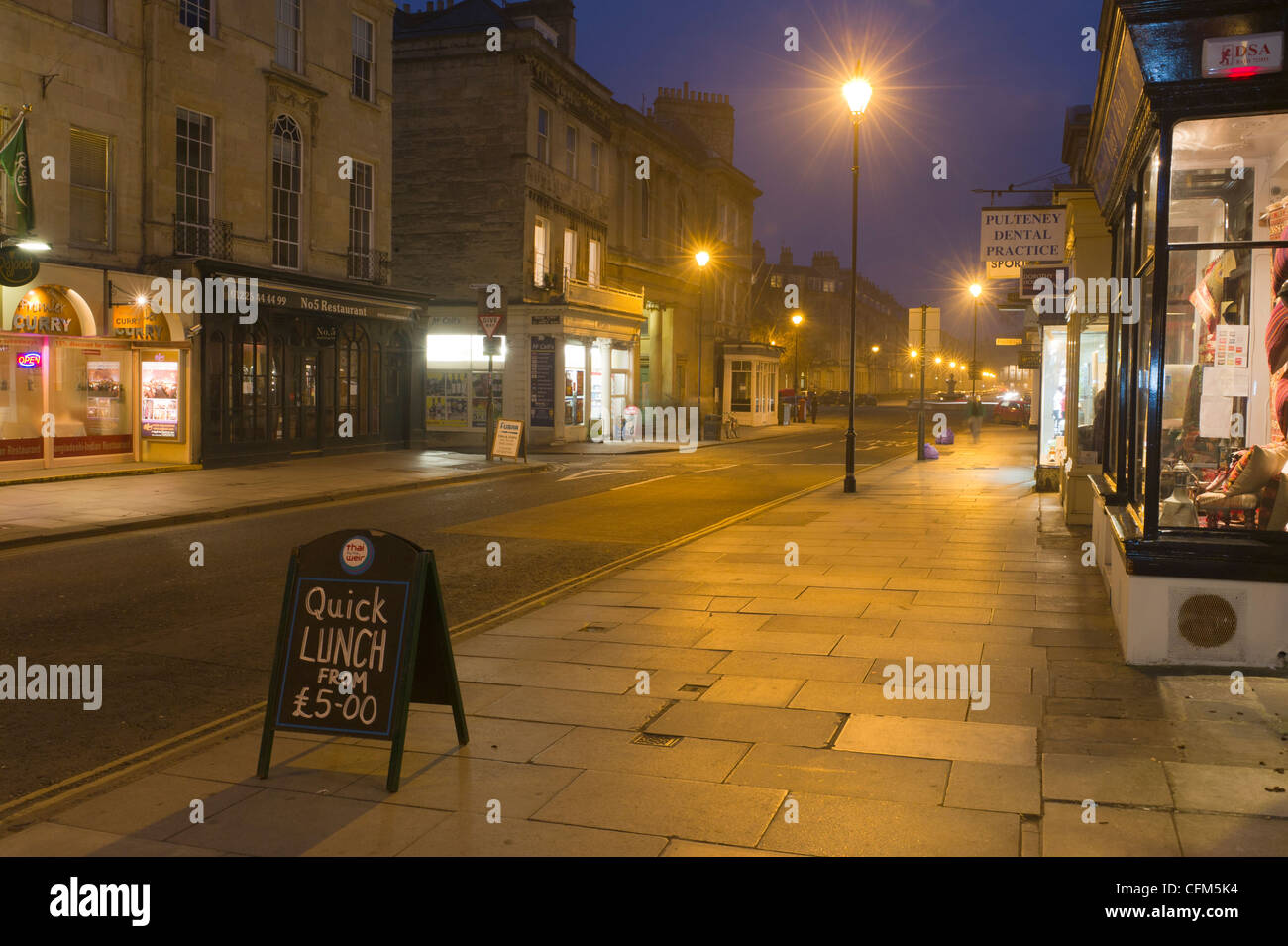 Pulteney street Bath lit by artificial street and shop lighting after dark Stock Photo