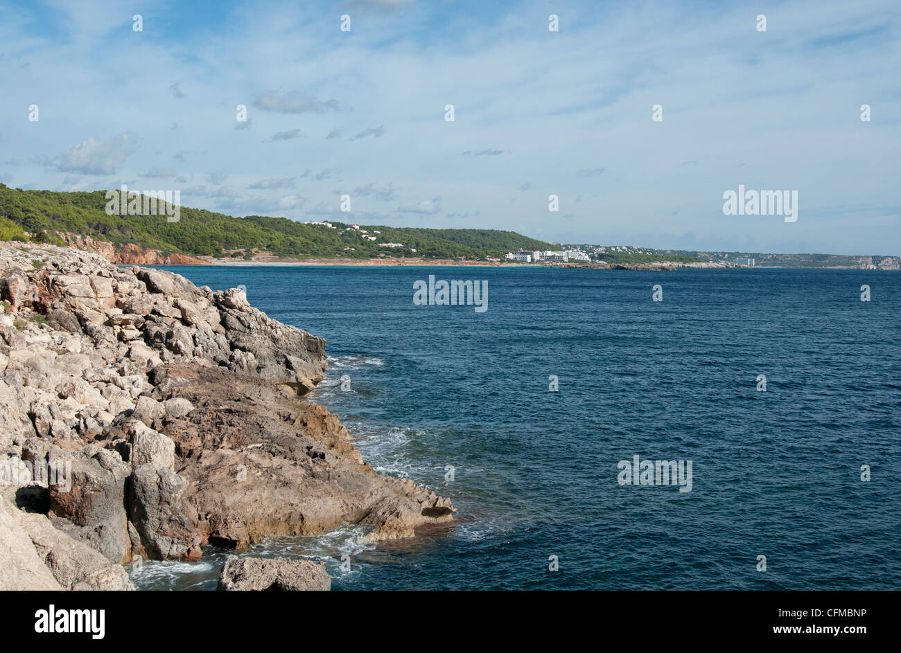 Looking along the Menorcan coastline towards the beach resort of Sant Tomas on the island of Menorca Spain Stock Photo