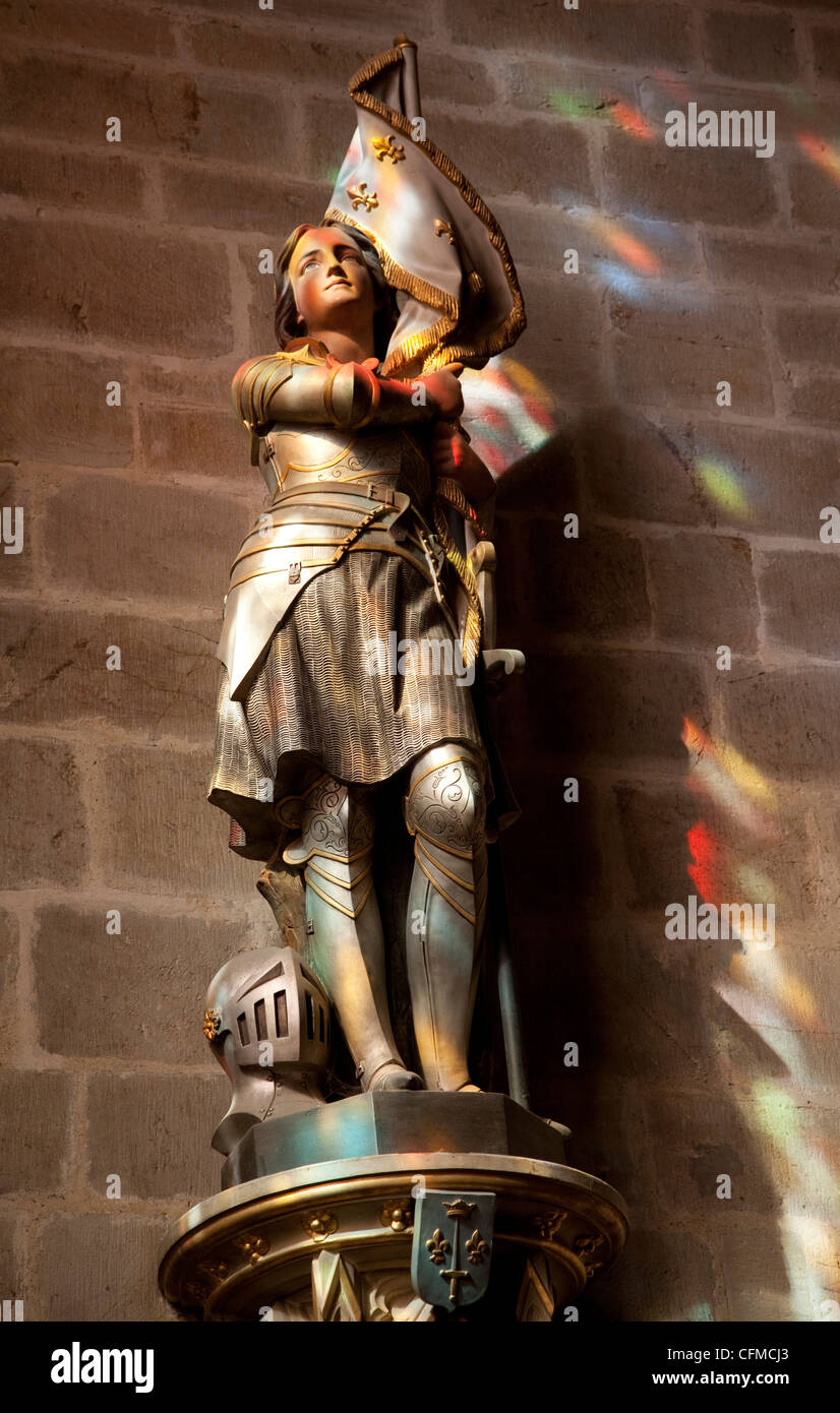 Statue of St. Joan of Arc with coloured light from stained glass, Church of Notre Dame, Vitre, Brittany, France, Europe Stock Photo