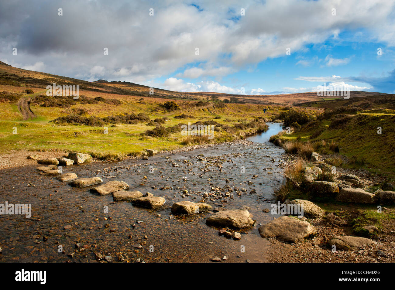 River Lyd with stepping stones and footbridge leading to Doe Tor Stock Photo