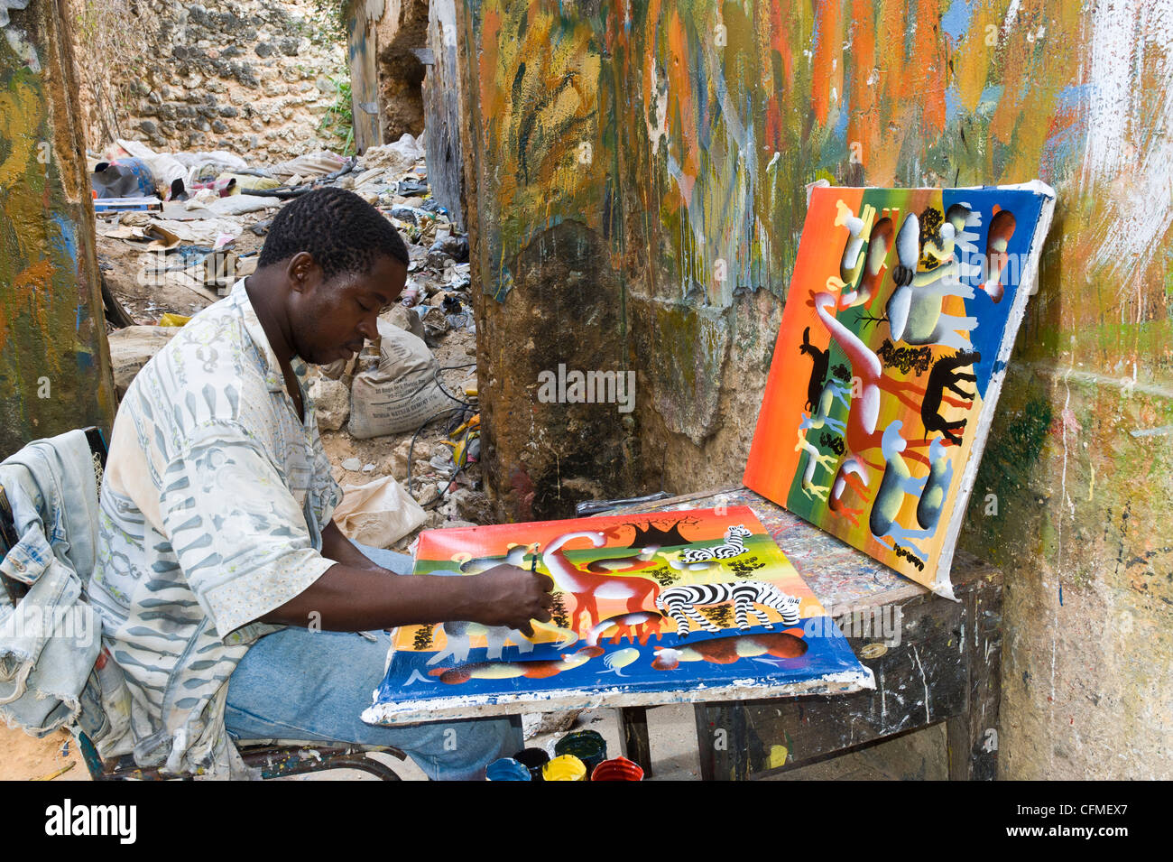 Artist painting in 'Tinga Tinga' Style in Stone Town Zanzibar Tanzania Stock Photo
