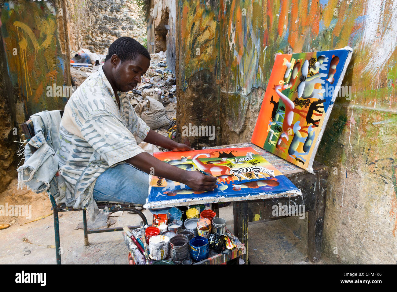 Artist painting in 'Tinga Tinga' Style in Stone Town Zanzibar Tanzania Stock Photo