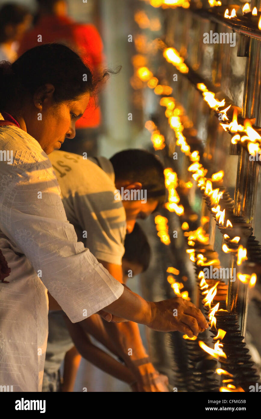 Devotee lighting candles, Kandy, Sri Lanka, Asia Stock Photo Alamy