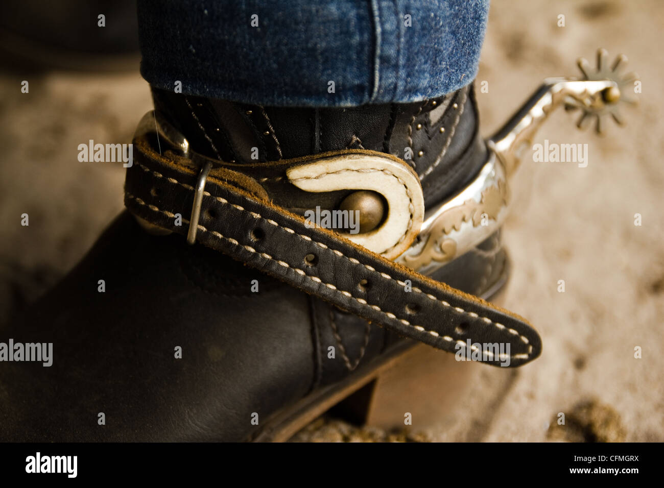 A cowgirl boot with a sliver spur on. Stock Photo