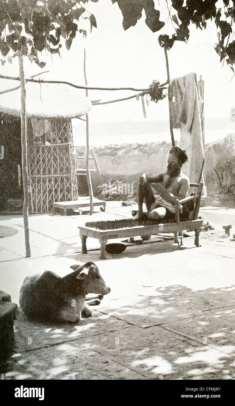 This photo shows a Yogi (a yoga practitioner) on a bed of spikes (nails
