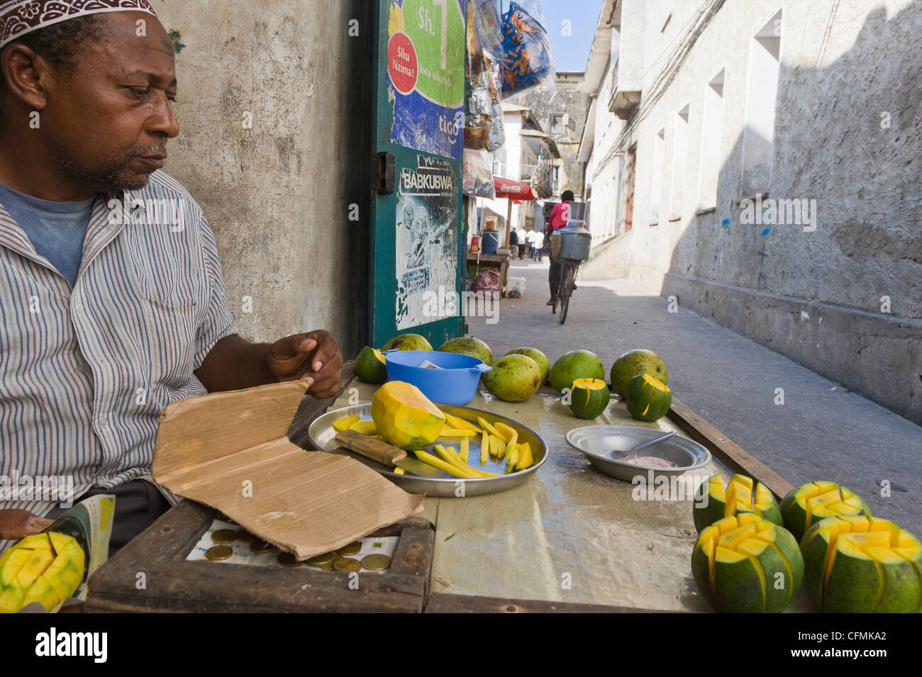 Vendor sells fresh mangoes in Stone Town Zanzibar Tanzania Stock Photo