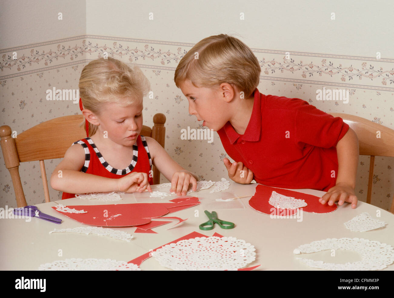 Young Boy and Girl Making Valentines. Stock Photo