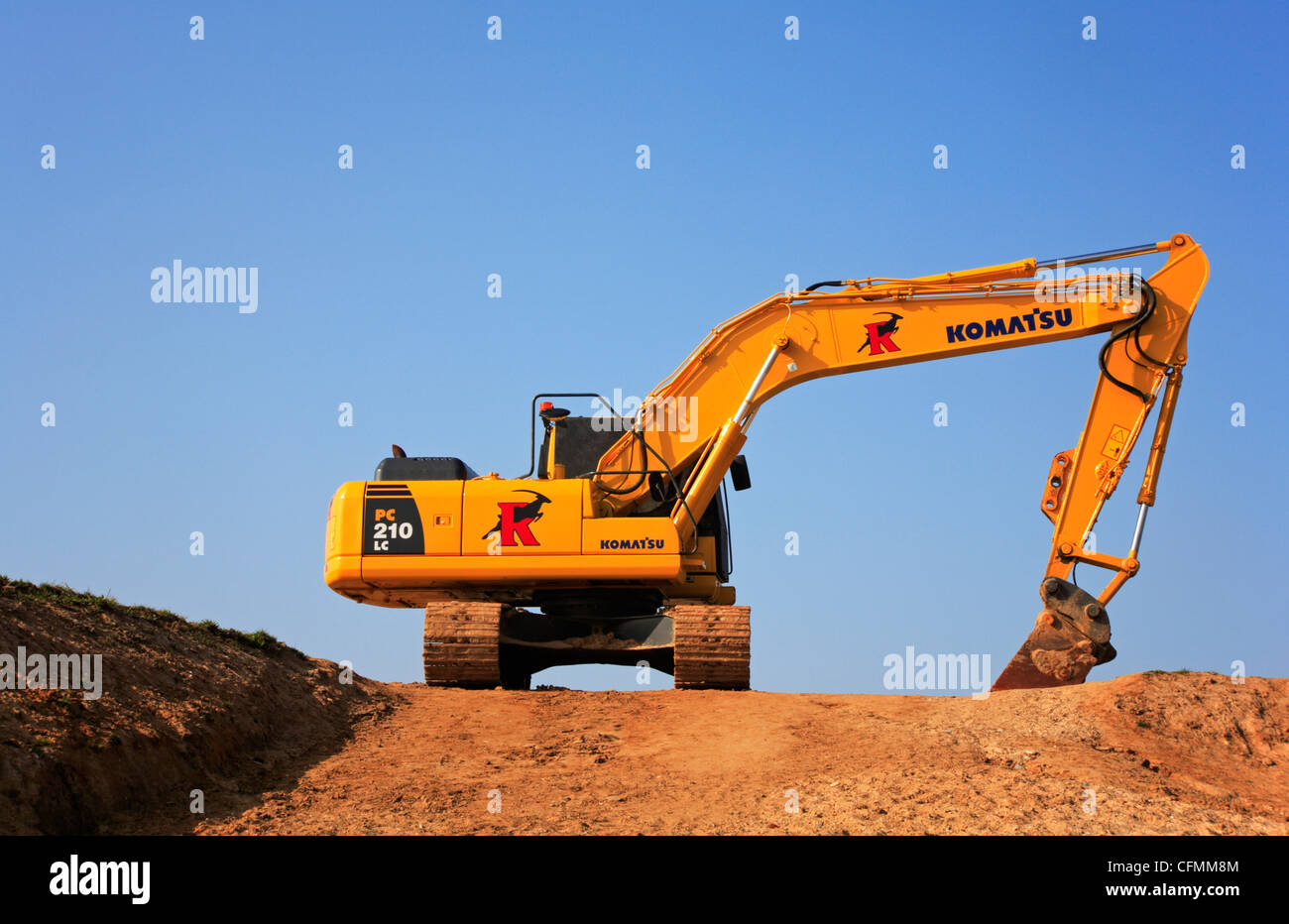 A mechanical digger positioned on the cliff top at Happisburgh, Norfolk, England, United Kingdom