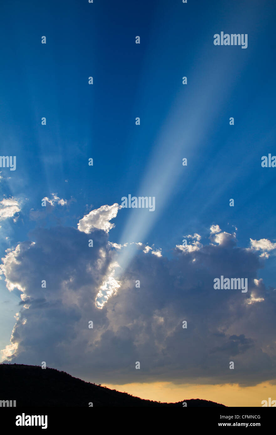 Sun rays shining through clouds over mountain CMD Photo Stock Photo - Alamy