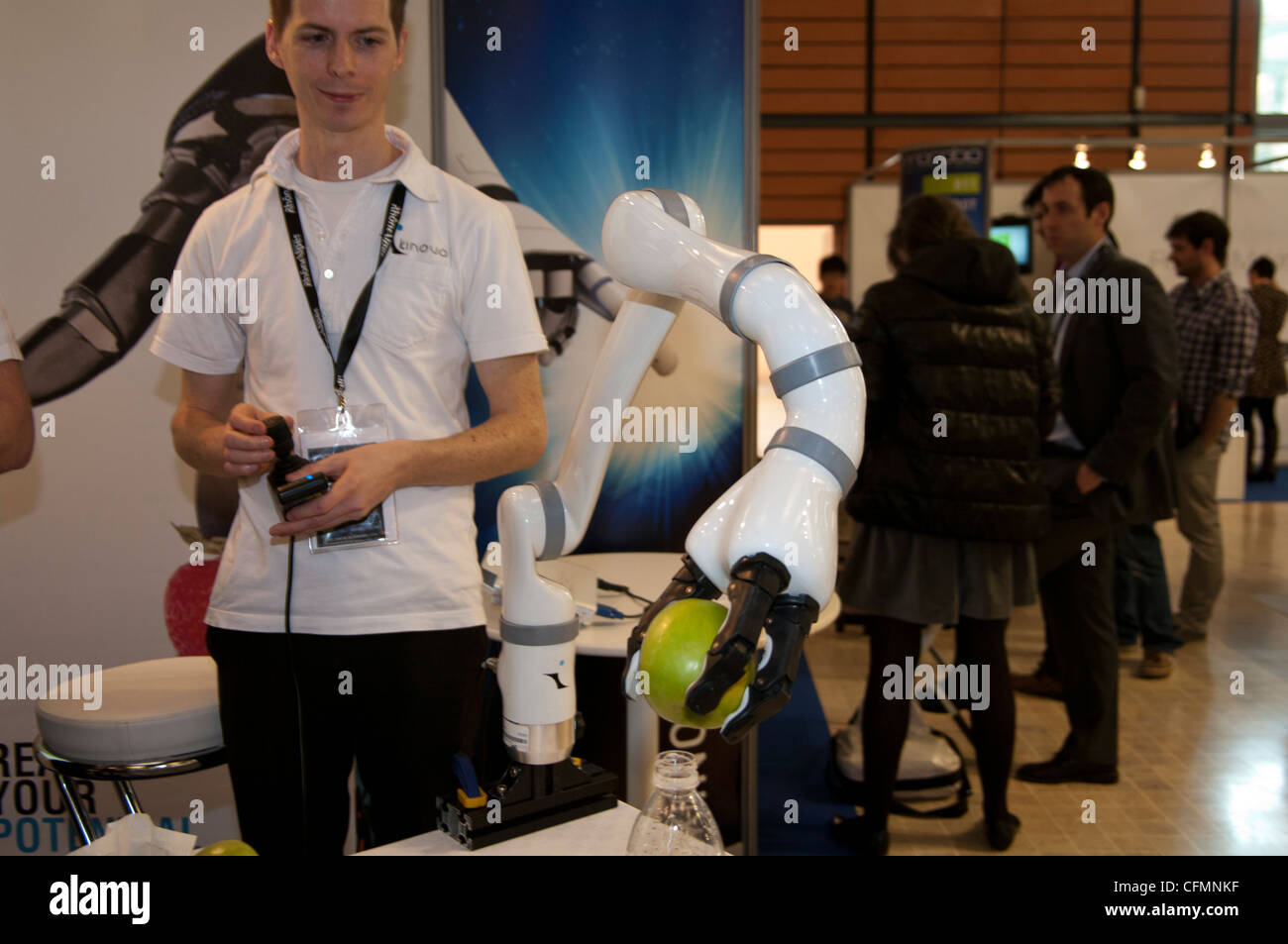Jaco robot arm remotely from Kinova robotics company puts an apple onto a bottle in in robotics Photo -