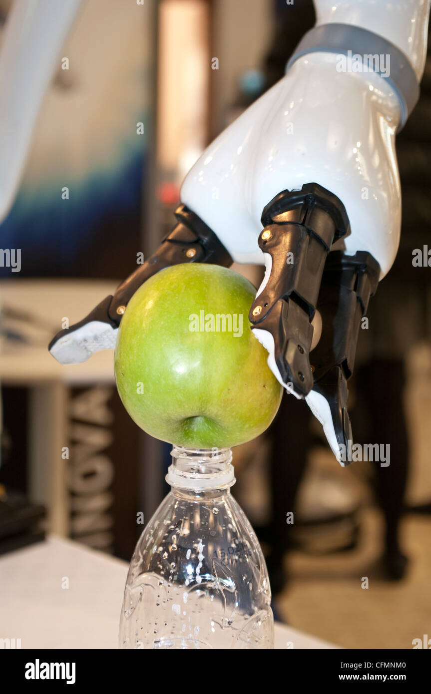 Jaco robot arm from Kinova robotics company put an apple onto a bottle in  INNOROBO European summit in robotics Stock Photo - Alamy