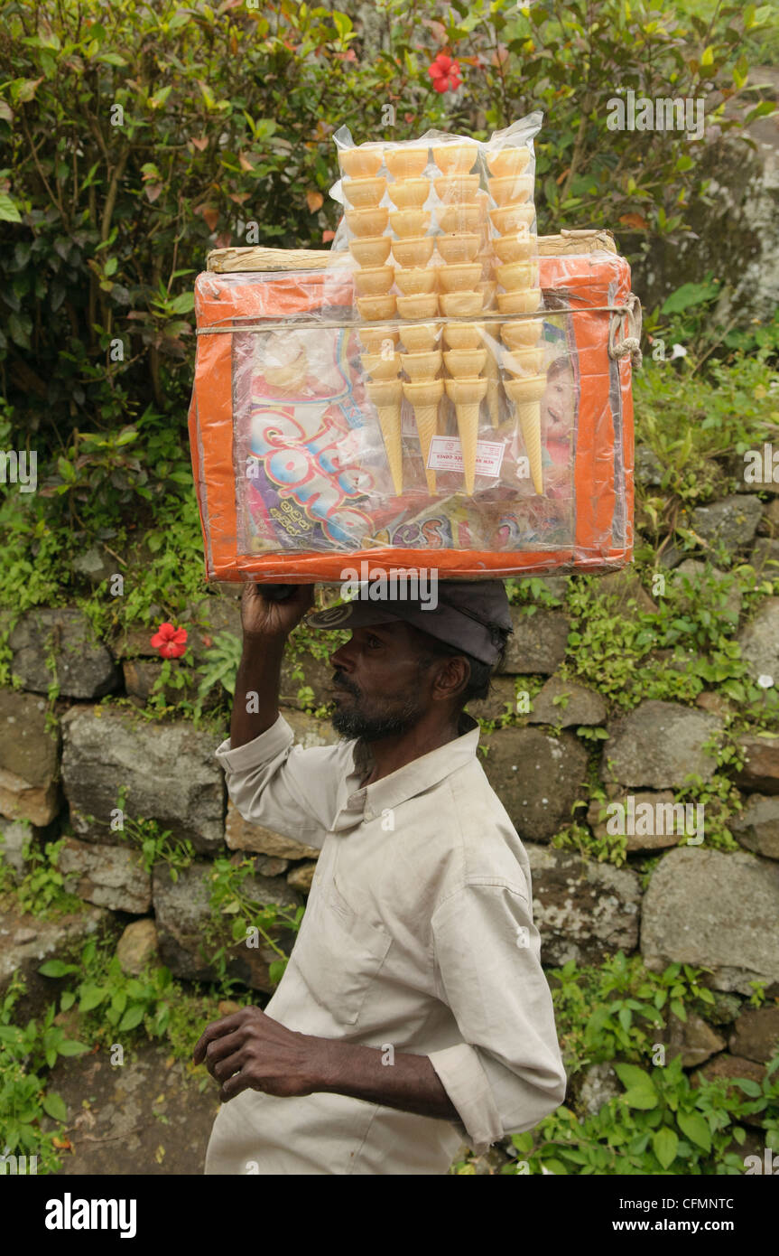 ice cream vendor carries his cones on his head near Kandy, Sri Lanka Stock Photo