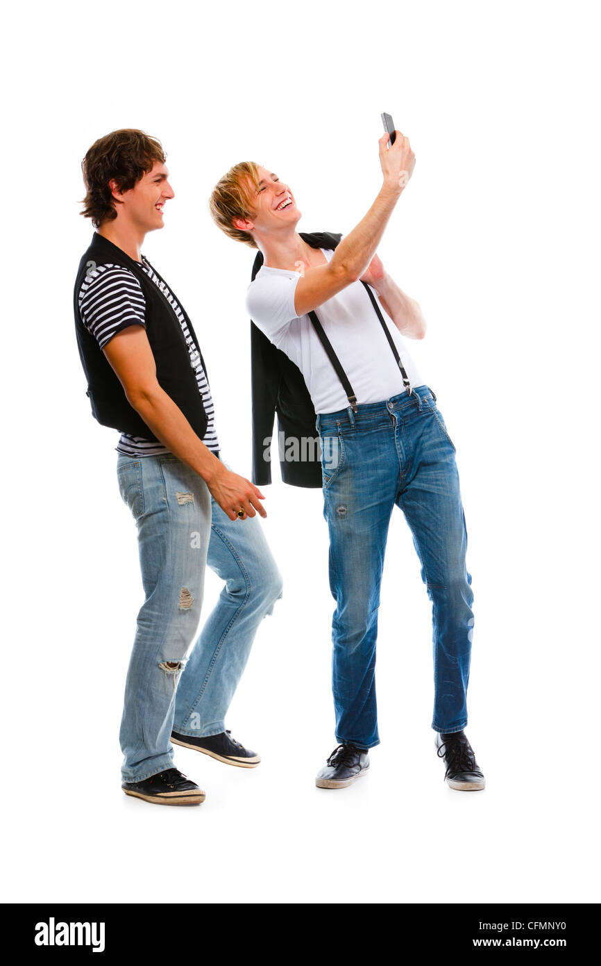 Two modern teenage boys making photos on cell phone. Isolated on white Stock Photo