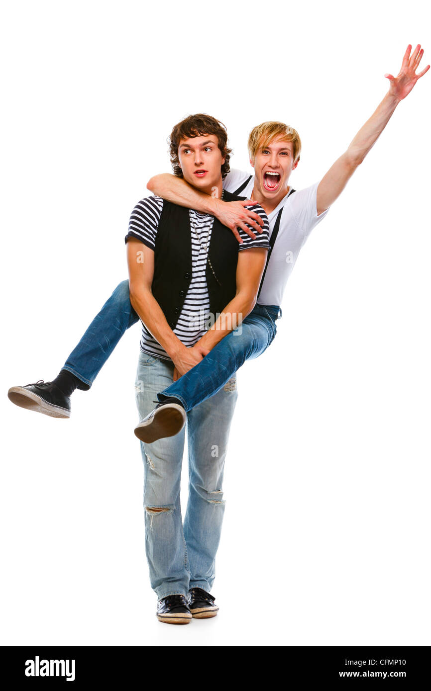 Cheerful teenager piggy backing his friend. Isolated on white Stock Photo