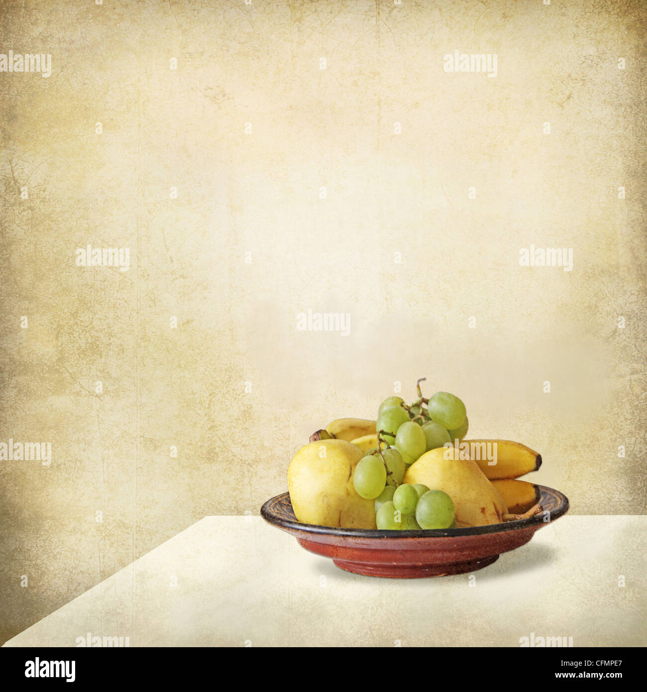 Grunge still life of a light interior, a table and a  tray full of fruits, grapes, bananas, pears. Stock Photo