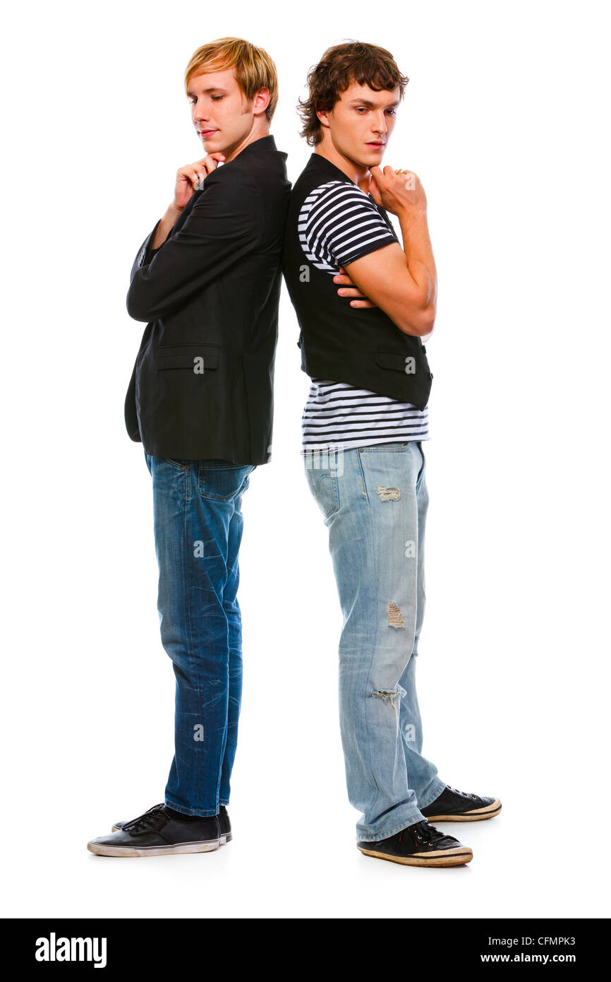 Two thoughtful young men standing back to back. Isolated on white Stock Photo