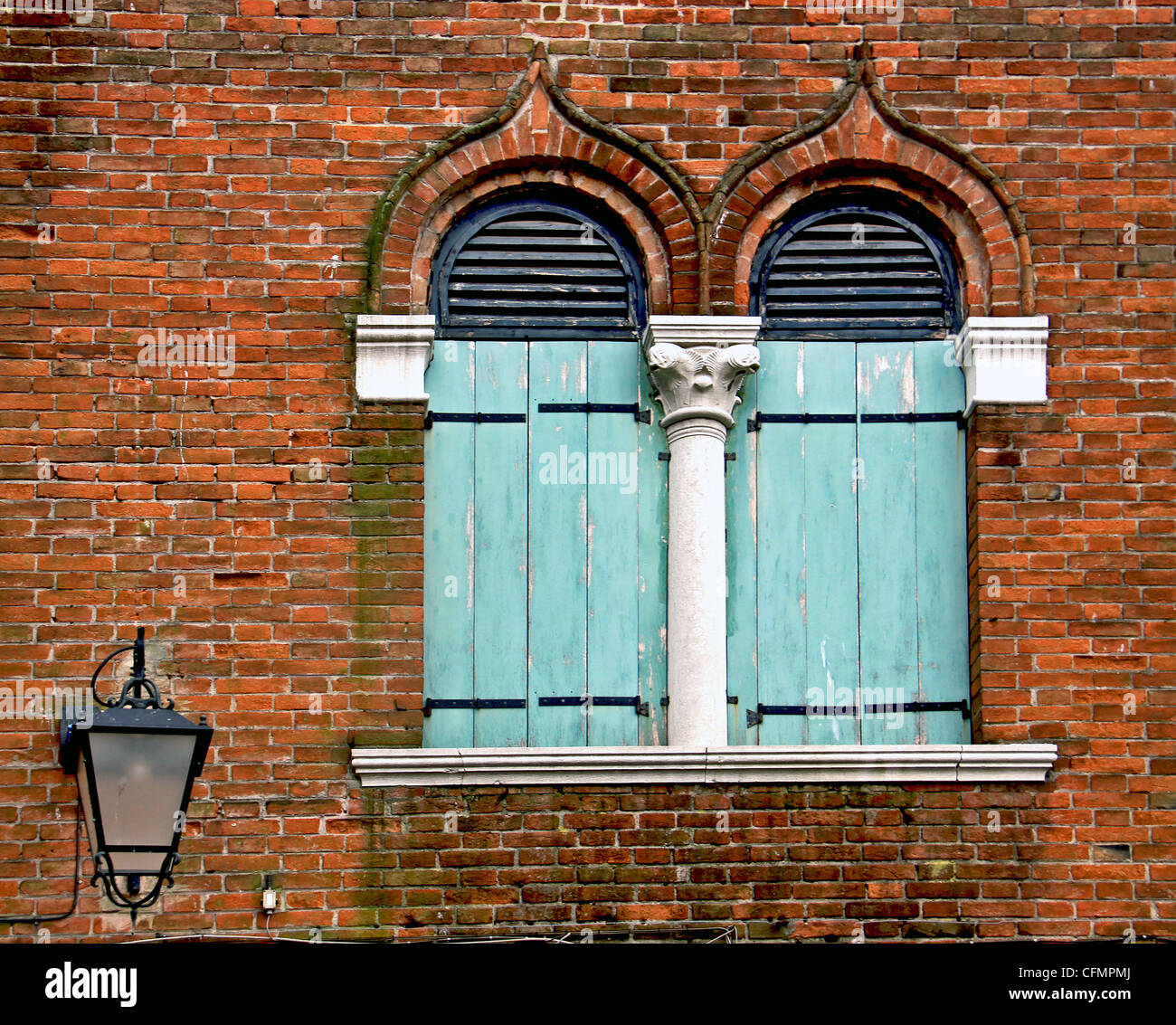 Typical Venetian architecture named bifora: two arch pointed windows separated by a white marble column Stock Photo