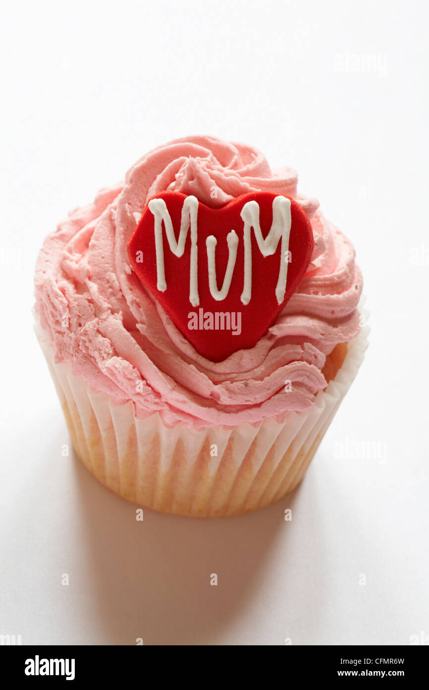 strawberry cupcake with the word mum iced on red heart for Mothering Sunday, Mothers Day isolated on white background Stock Photo