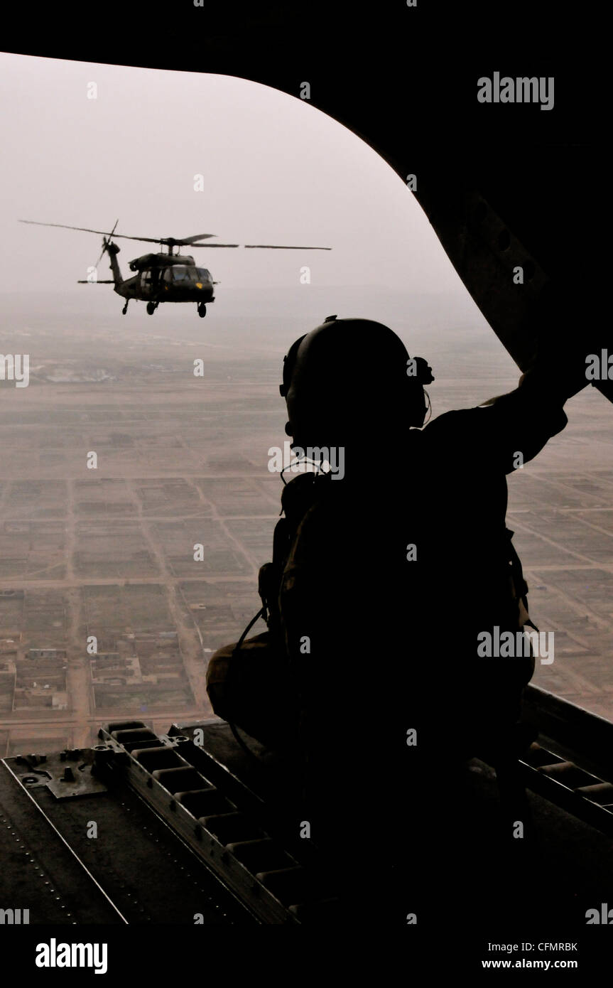 A crew chief assigned to Company B, Task Force Lobos, 1st Air Cavalry Brigade, 1st Cavalry Division, scans the skies of northern Afghanistan from the back of a CH-47 Chinook cargo helicopter March 15. Stock Photo