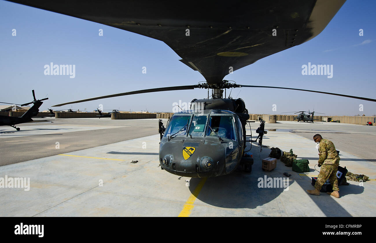 A UH-60 Black Hawk crew chief assigned to Company A, Task Force Lobos, 1st Air Cavalry Brigade, 1st Cavalry Division, prepares for a flight March 14. Stock Photo