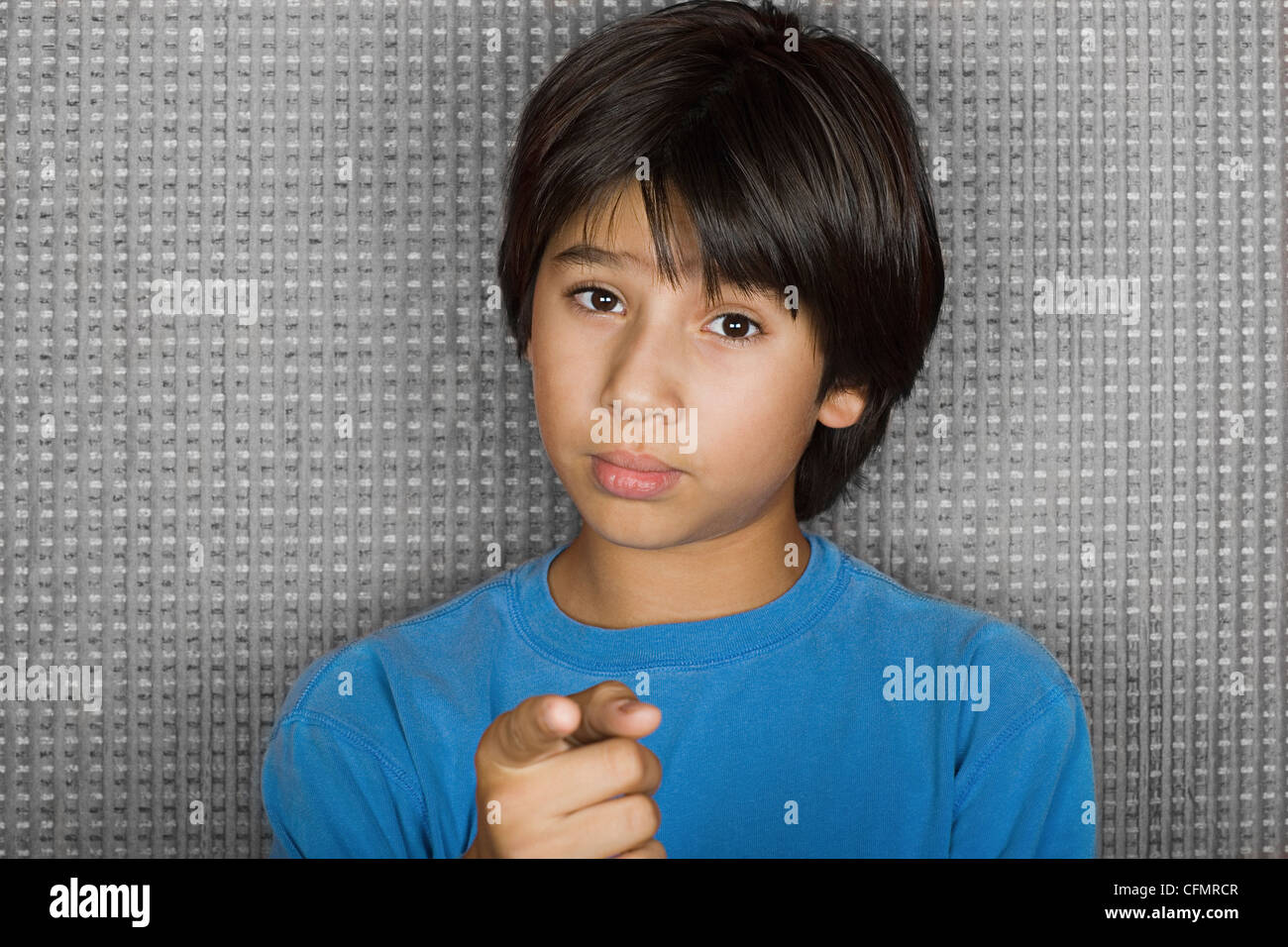Studio portrait of young man pointing at camera Stock Photo