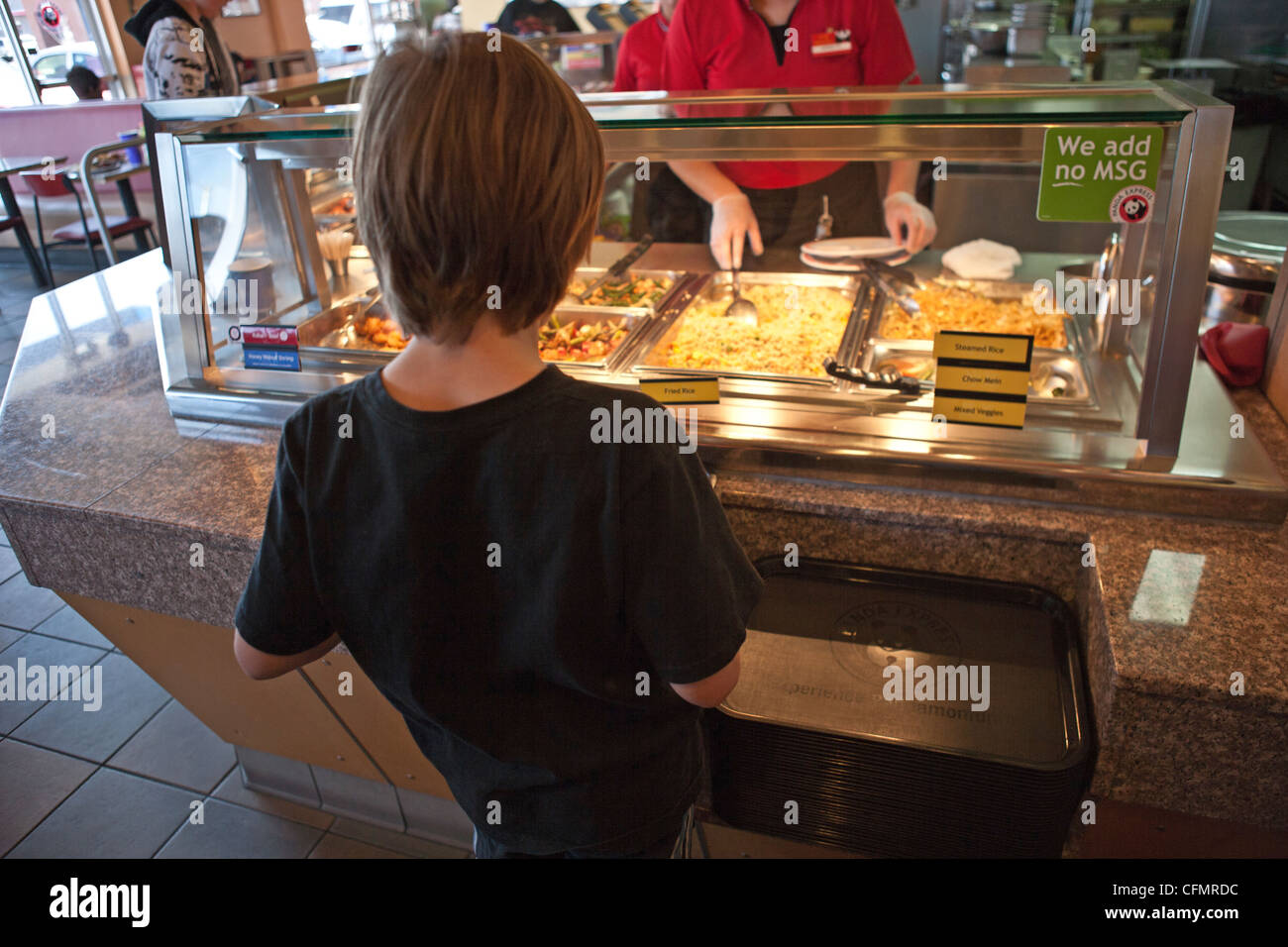 A nine year old boy orders Chinese fast food at Panda Express. Stock Photo