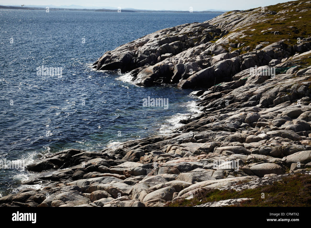 Coast of Norway. Rocks and sun reflection. Fresh air. Stock Photo