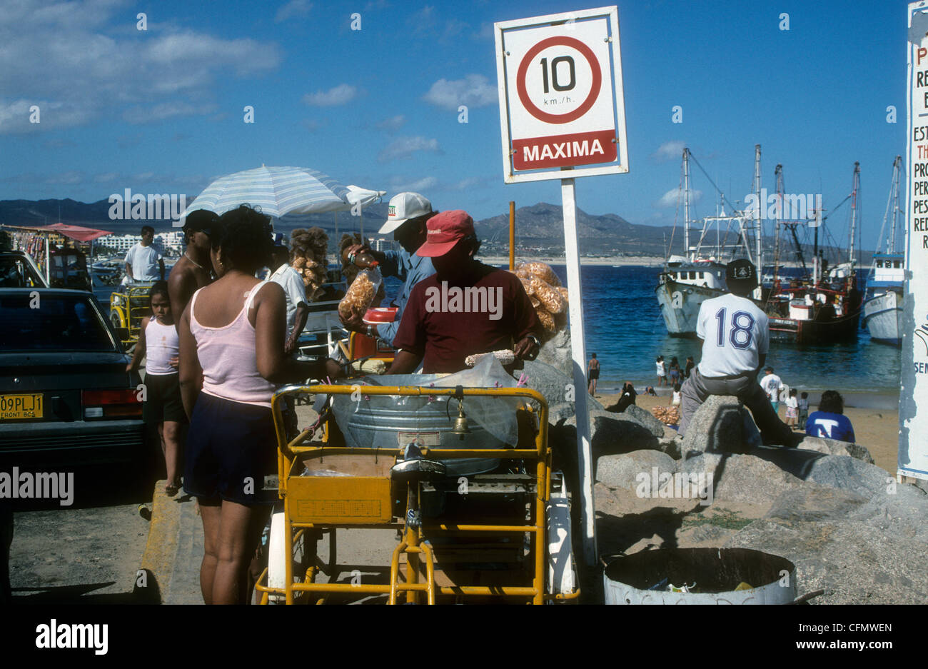 A street vendor sells snacks at a beach in Cabo San Lucas, Baja
