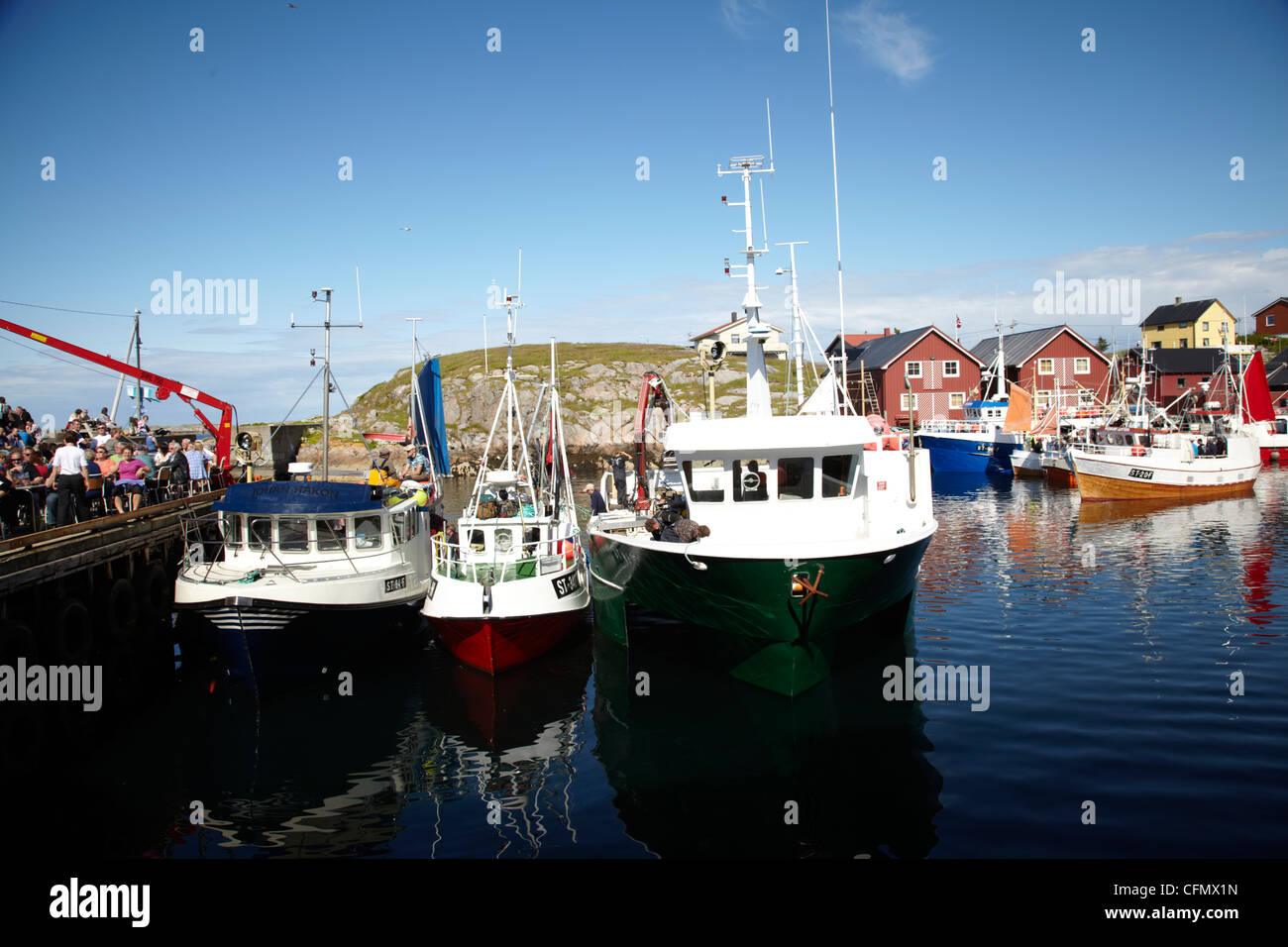 Fiskebåtar i hamn. Fishing boat in a port of Mausund. Norway Blue sky. Blue water. Stock Photo