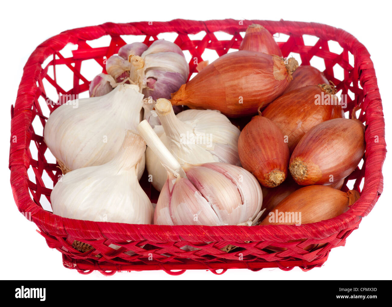 Shallots and garlic in a red basket isolated on white Stock Photo Alamy