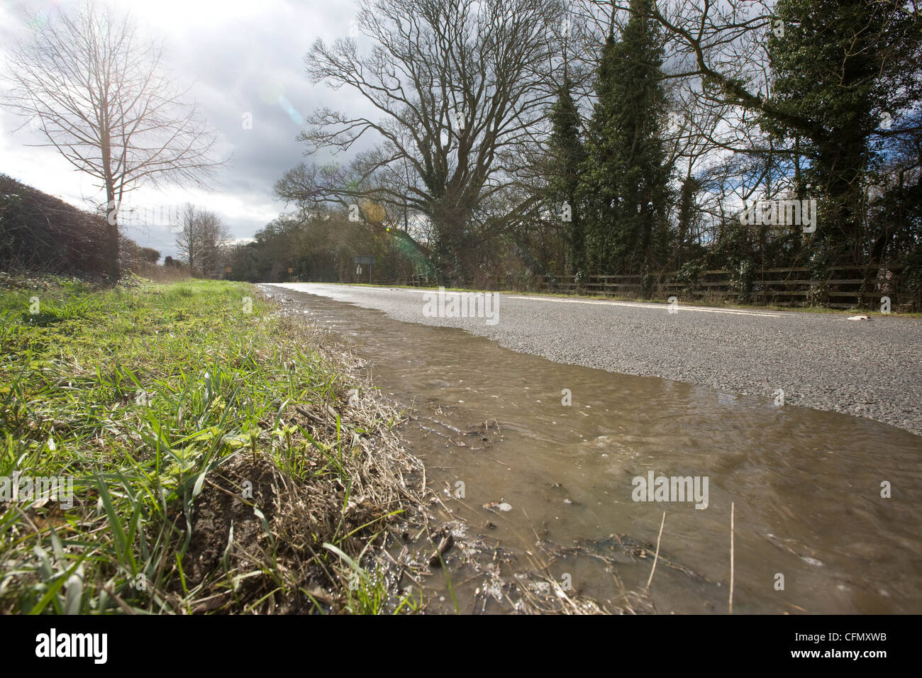 Water running down a road from a burst water pipe during the drought of