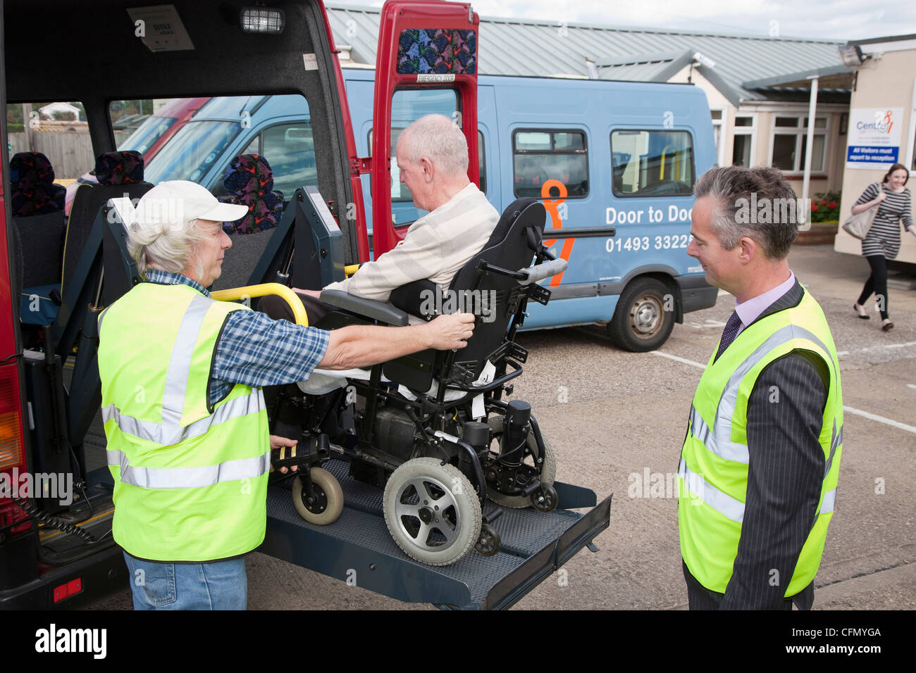 Mike Jackson, Director of Norfolk County Council's transport division (rght), learns about disabled charity's transport service. Stock Photo