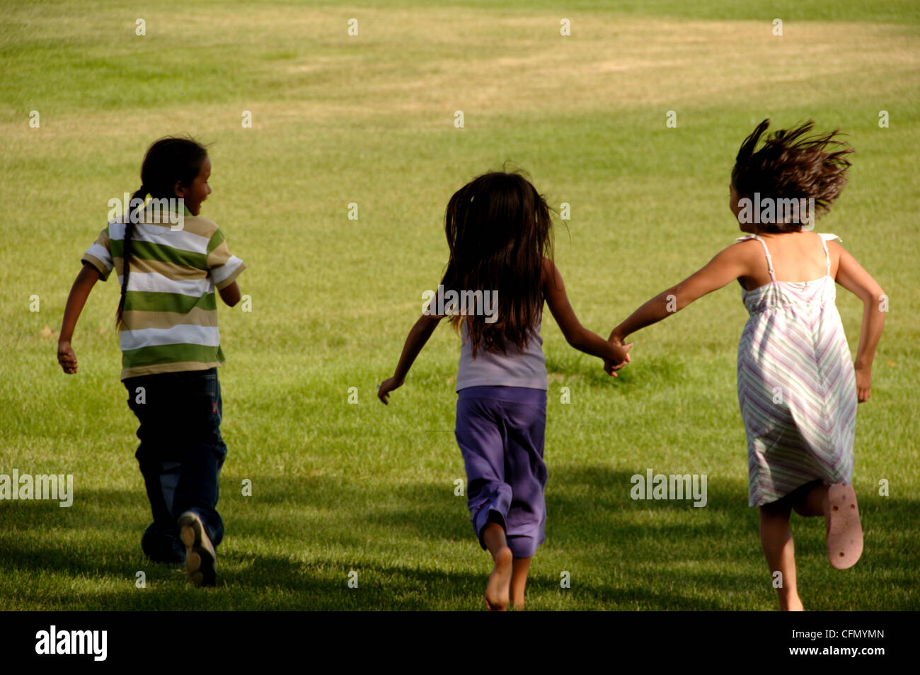 Children Running in Park Stock Photo
