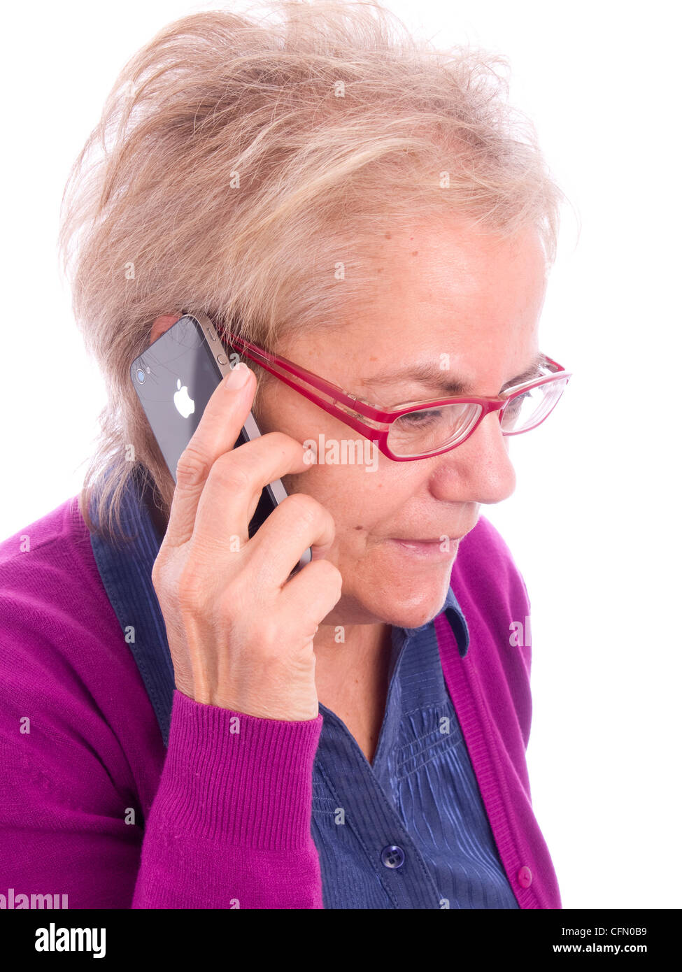 Close up of mature woman with red glasses talking on iPhone Stock Photo