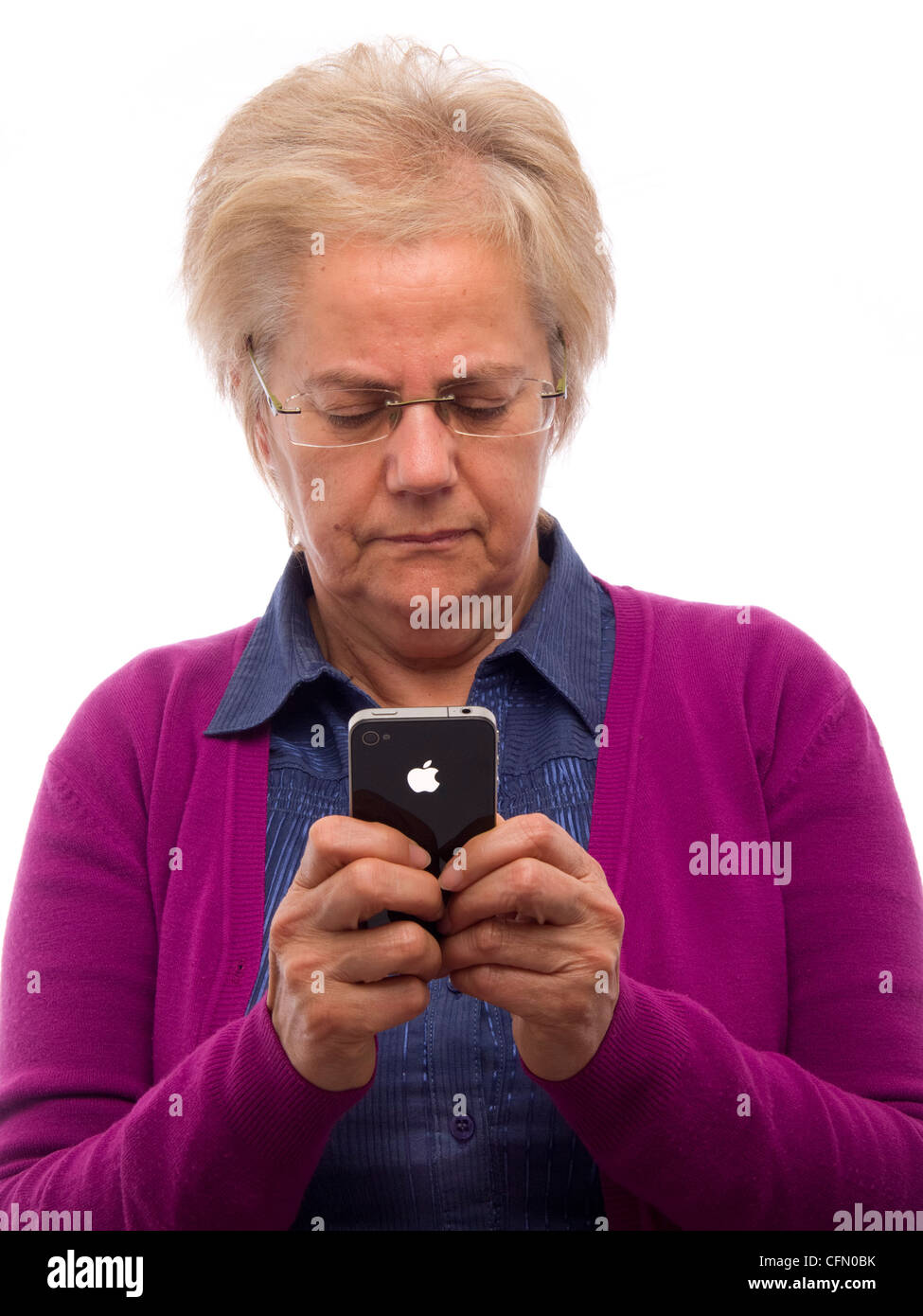 Mature woman using iPhone Stock Photo