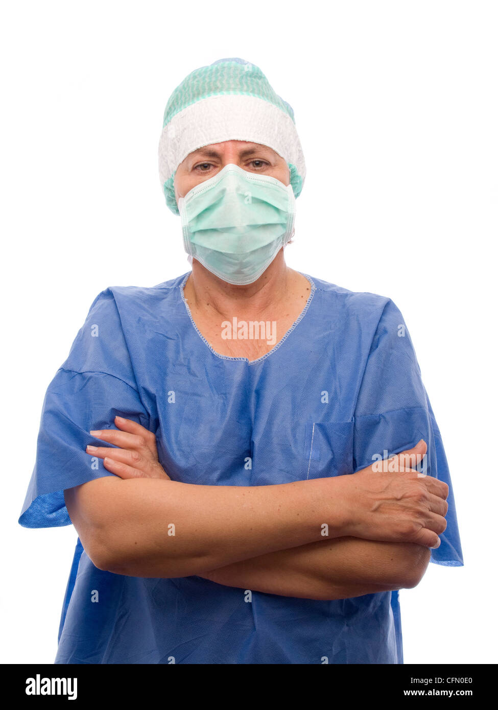 Portrait of female middle aged doctor wearing surgical face mask with arms crossed isolated on white background Stock Photo