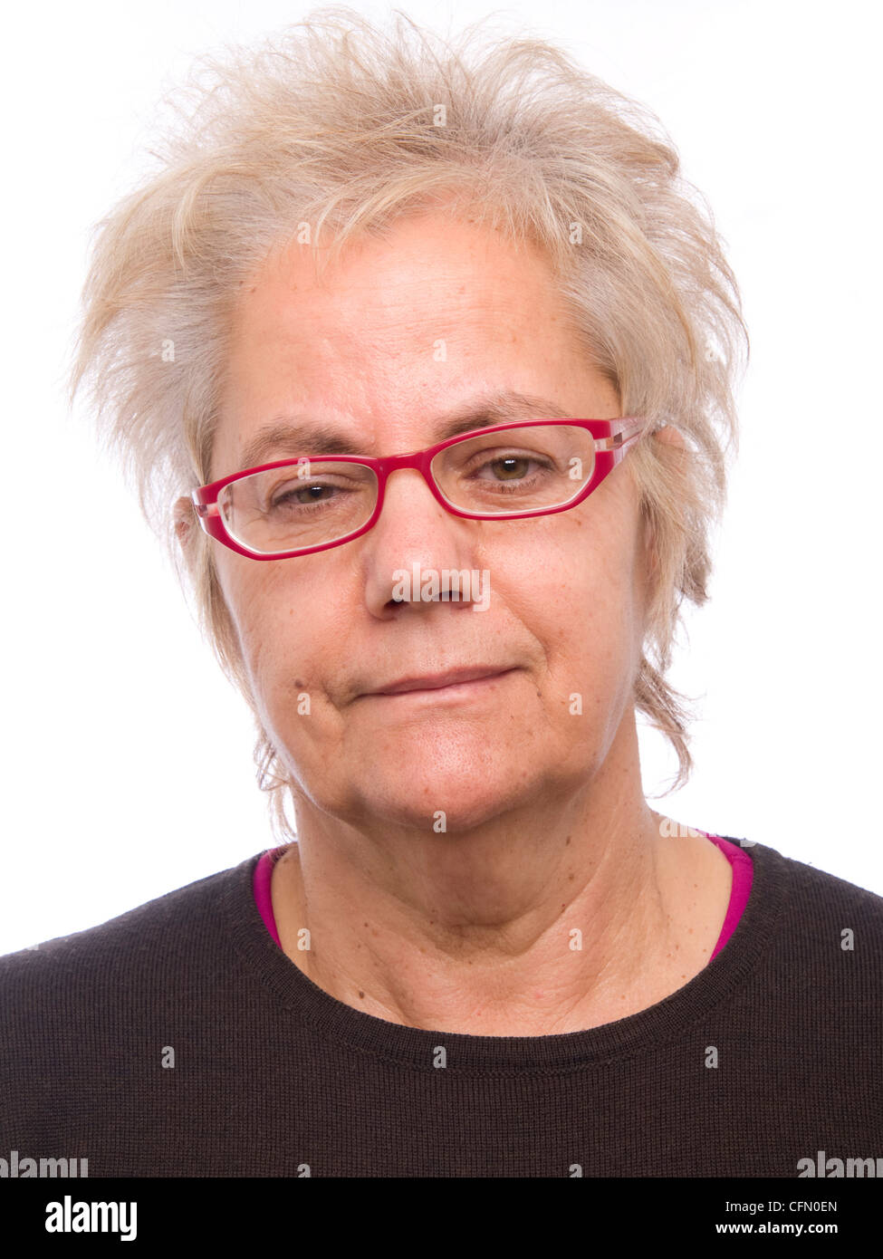 Portrait of a happy middle aged woman with glasses and modern hairstyle looking at camera Stock Photo